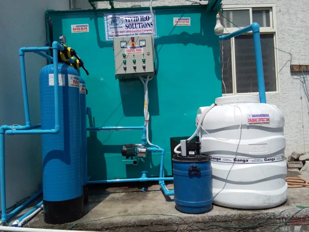 Packaged sewage treatment plant with automated control panel, aeration tank, chemical dosing unit, and chlorine contact tank